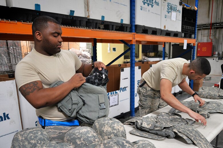 Staff Sgt. Nethiel, NCO in charge IPE, and Senior Airman Yeudy, individual protective equipment journeyman, account for and inspect IPE at an undisclosed location in Southwest Asia April 20, 2015. The IPE team is responsible for performing inspections frequently to ensure gear is serviceable. (U.S. Air Force photo/Tech. Sgt. Jeff Andrejcik)