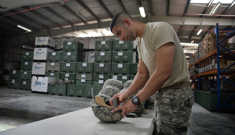 Senior Airman Yeudy, individual protective equipment journeyman, inspects a gas mask at an undisclosed location in Southwest Asia April 20, 2015. The IPE team here is responsible for keeping track of and inspecting 119,701 pieces of gear. (U.S. Air Force photo/Tech. Sgt. Jeff Andrejcik)