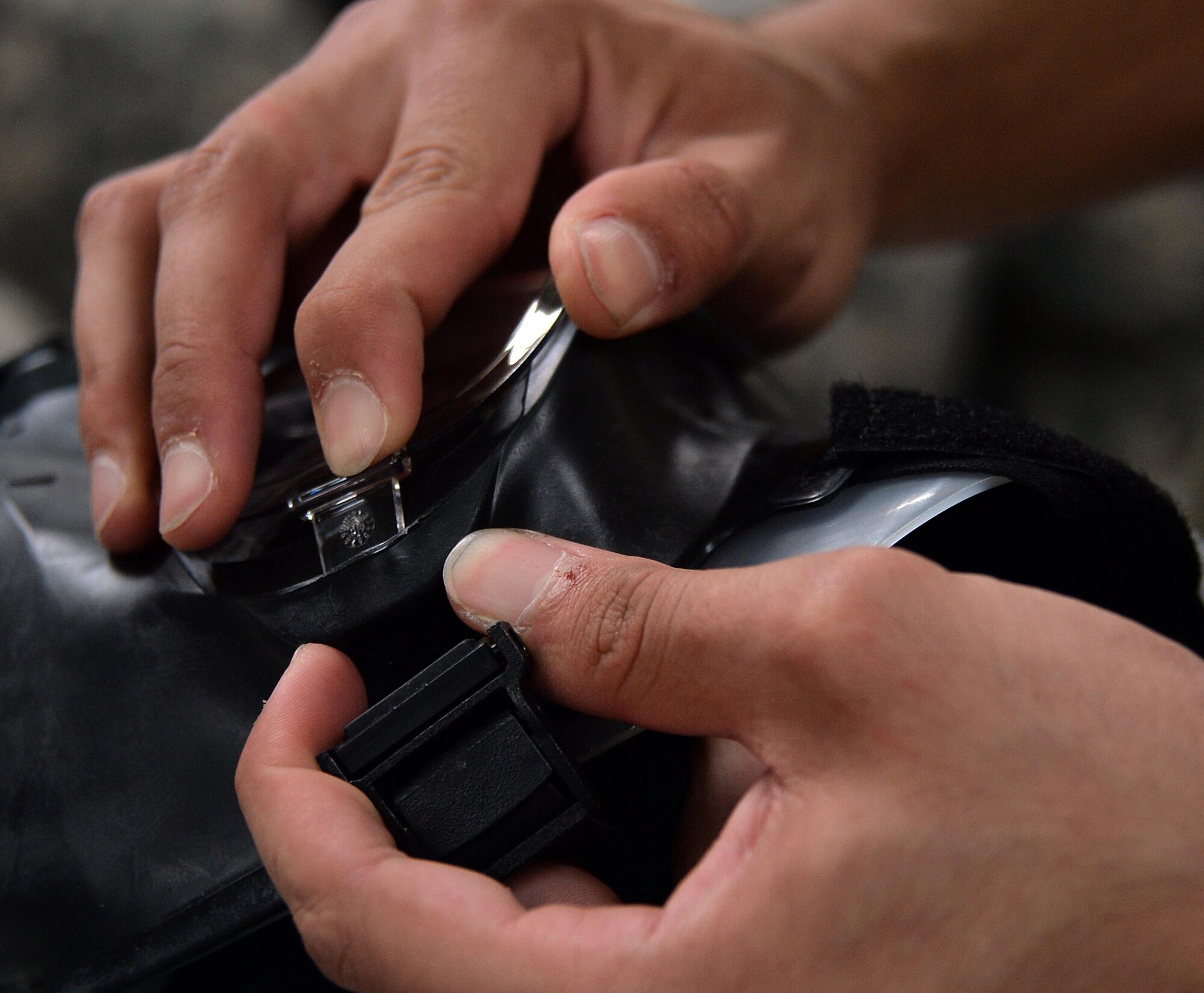 Senior Airman Yeudy, individual protective equipment journeyman, performs a gas mask inspection at an undisclosed location in Southwest Asia April 20, 2015. The IPE team here is responsible for keeping track of and inspecting 119,701 pieces of gear. (U.S. Air Force photo/Tech. Sgt. Jeff Andrejcik)