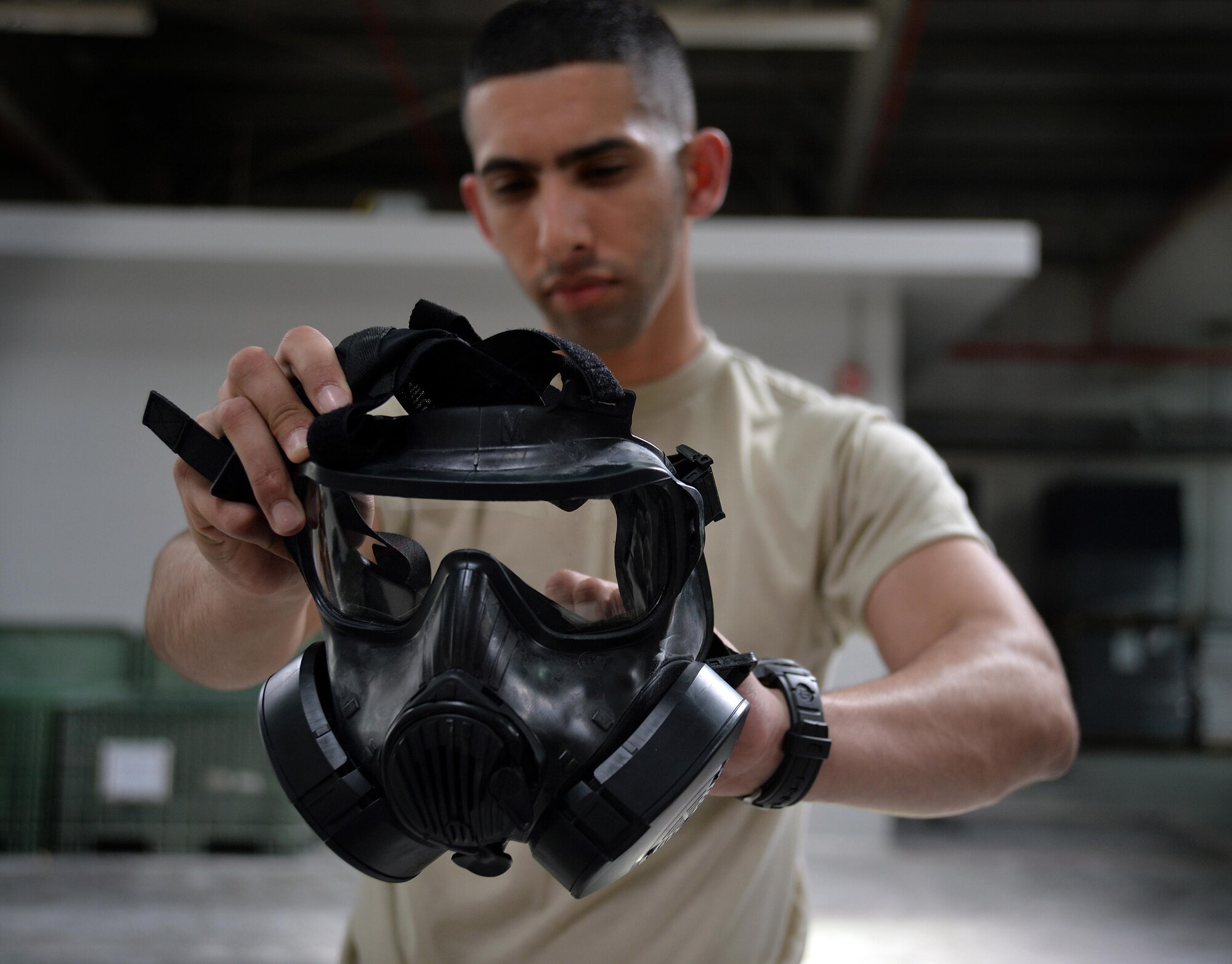 Senior Airman Yeudy, individual protective equipment journeyman, performs a gas mask inspection at an undisclosed location in Southwest Asia April 20, 2015. The IPE team here is responsible for keeping track of and inspecting 119,701 pieces of gear.  (U.S. Air Force photo/Tech. Sgt. Jeff Andrejcik)