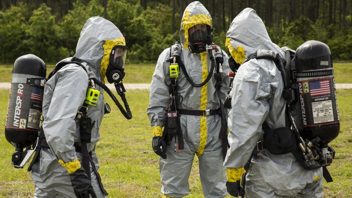 Explosive ordnance disposal technicians with 2nd EOD Company, 8th Engineer Support Battalion, prepare to conduct a chemical, biological, radiological, and nuclear training operation during their pre-deployment training aboard Marine Corps Base Camp Lejeune, North Carolina, May 6, 2015. During the scenario, the Marines had to conduct reconnaissance on an explosive device, identify the agent in the device and defuse it before it detonated.