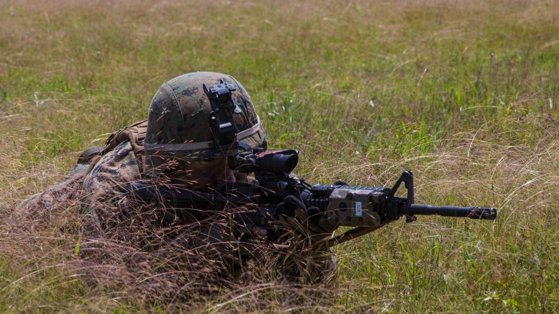 A Marine with 2nd Ground Sensor Platoon, 2nd Intelligence Battalion provides suppressive fire against the enemy while members of his fire team bound from one obstacle to the next during a live fire range aboard Camp Lejeune, N.C., May 13, 2015. Marines with the platoon spent the day running fire-team and squad-size rushes in order to stay proficient in infantry tactics.