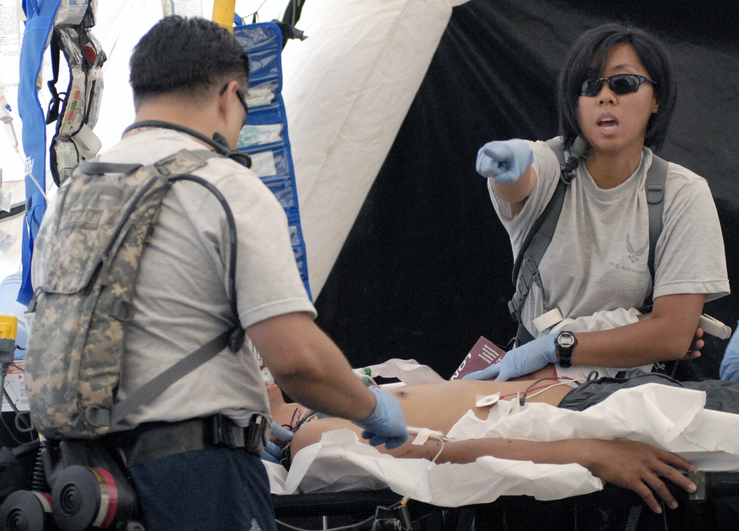 Airmen from the Hawaii Air National Guard's 154th Medical Group assist "victims" of a simulated dirty bomb detonation Dec. 16, 2010, at Bellows Air Force Station, Hawaii, during a homeland defense response validation exercise.