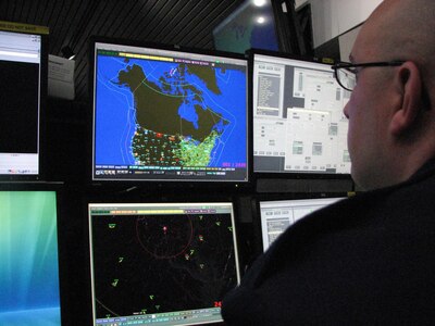 New York Air National Guard Staff Sergeant Lawrence Brooks, an air surveillance technician at EADS, mans the monitor tracking Santa’s descent from the North Pole.