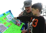 Army Spc. Crystal Houston, a Louisiana National Guardsman, looks at a colorful sign her 6-year-old son, Micah, created for her as she returns home from Iraq to Jackson Barracks, New Orleans, Dec. 22, 2010.  The 256th Infantry Brigade Combat Team completed a 365-day deployment in support of Operation Iraqi Freedom and Operation New Dawn.