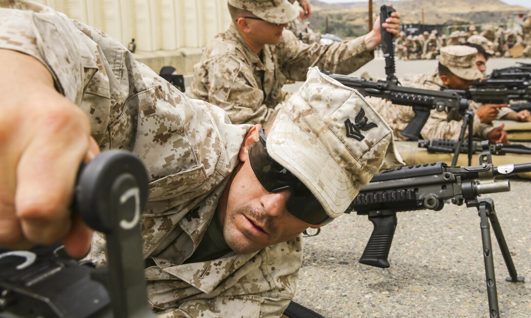 Petty Officer Second Class Robert Griffin, a religious program specialist with the 13th Marine Expeditionary Unit, changes the barrel of an M240B Light Machine Gun aboard Camp Pendleton, Calif., during weapons familiarization portion of the MEUs Command Post Exercise 1, May 14, 2015. The exercise served to test the unit's command and control ability as well as satisfy annual training requirements.