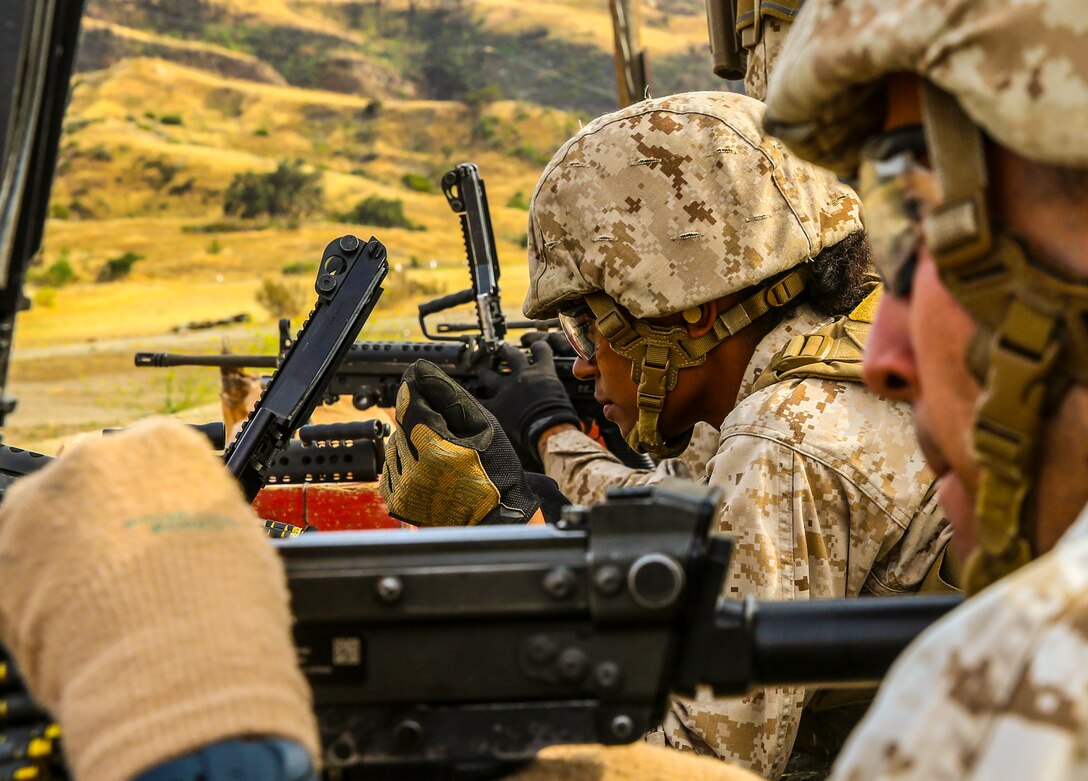 Cpl. Vanessa Polanco, Marine Air-Ground Task Force Planner with the 13th Marine Expeditionary Unit, fires an M249 Squad Automatic Weapon aboard Camp Pendleton, Calif., during weapons familiarization portion of the MEUs Command Post Exercise 1, May 14, 2015. The exercise served to test the unit's command and control ability as well as satisfy annual training requirements.