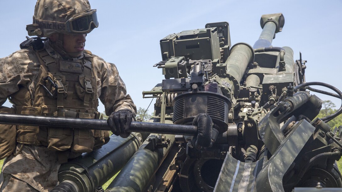 An artillerymen with Combined Arms Company Artillery Platoon, 3rd Battalion, 8th Marine Regiment cleans an M777A2 Howitzer after firing rounds during a week-long training exercise at Marine Corps Base Camp Lejeune, North Carolina, May 11-15. The newly formed unit made up of Marines from Bravo and Charlie Batteries, 1st Battalion, 10th Marine Regiment tested their teamwork and versatility during the exercise, which is part of their preparation for an upcoming deployment in support of the Black Sea Rotational Force based in Romania.