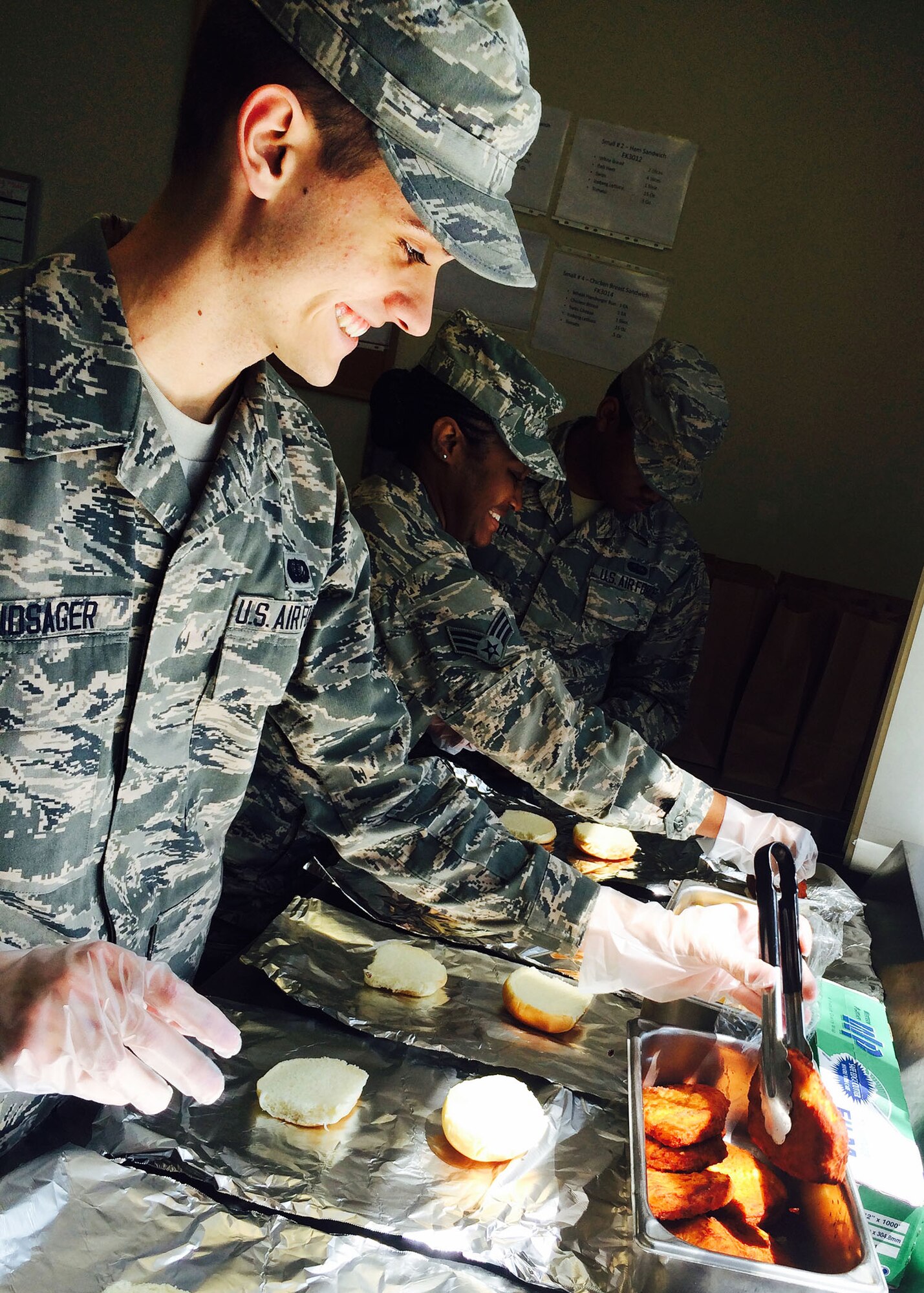 Senior Airman Alec Andsager, 944th Force Support Squadron services, prepares food April 5 during his annual tour deployment Kadena Air Base, Japan. (U.S. Air Force photo taken by Lt. Col. Debra Tofil)
