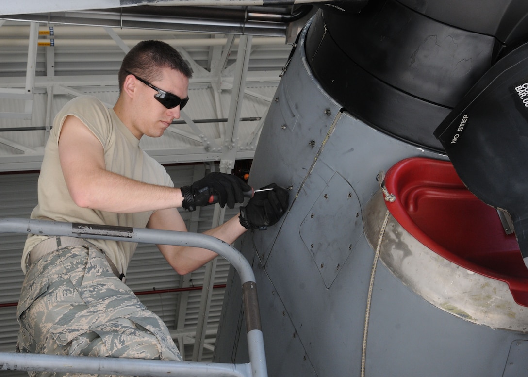 Air Force Reserve Senior Airman Matt Tyrell, 910th Maintenance Squadron crew chief, removes a panel to check oil levels in the propeller of a C-130H Hercules aircraft here, May 3, 2015. This is one of many inspections to make sure the aircraft is fully mission capable. (U.S. Air Force photo/Senior Airman Rachel Kocin)