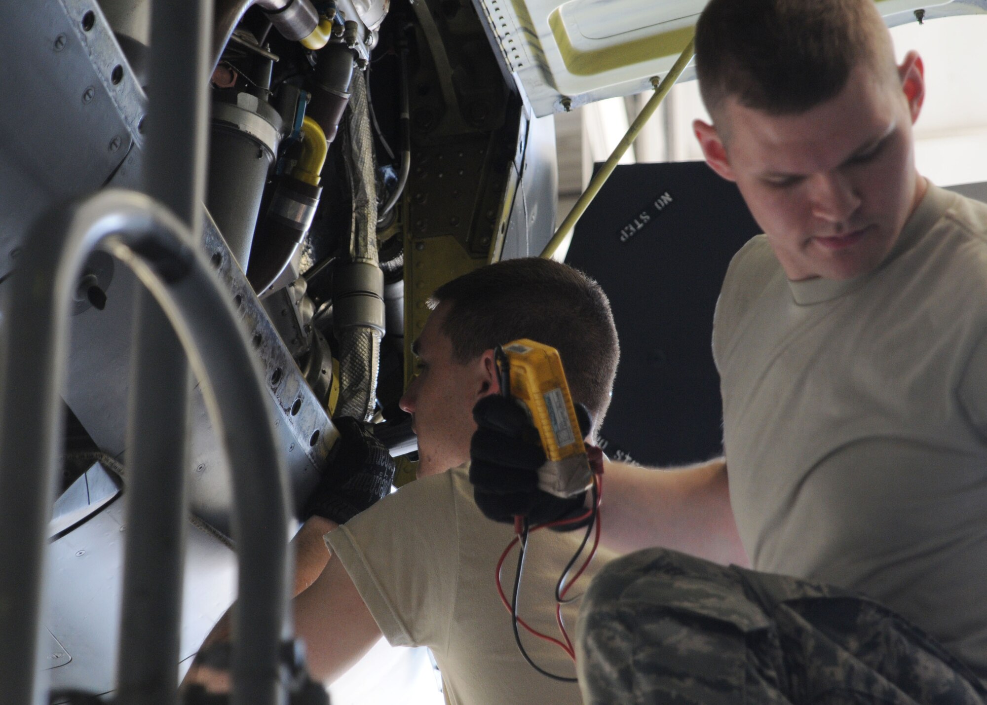 Air Force Reserve Senior Airman Taylor Weber and Senior Airman Matt Tyrell, 910th Maintenance Squadron crew chiefs, check fluid levels on a C-130H Hercules aircraft here, May 3, 2015. These checks are performed on the aircraft every fifteen days. (U.S. Air Force photo/Senior Airman Rachel Kocin)