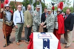 Senior leaders from the Virginia National Guard, Jamestown-Yorktown Foundation and state government gather to celebrate the 408th birthday of the Virginia National Guard and the founding of the Jamestown colony with a cake cutting May 14, 2015, at Jamestown Settlement in Williamsburg, Virginia. Brig. Gen. Timothy P. Williams, the adjutant general of Virginia, Command Sgt. Maj. Alan M. Ferris, Virginia National Guard Senior Enlisted Advisor, and Phillip Emerson, Executive Director of the Jamestown-Yorktown Foundation, cut the cake and were joined by Delegate T. Montgomery Mason of Virginia’s 93rd district, Homer Lanier, Interpretive Program Manager, Peter Armstrong, Senior Director of Museum Operations and Education, and Historical Interpreters Brian Beckley and Jay Templin.
