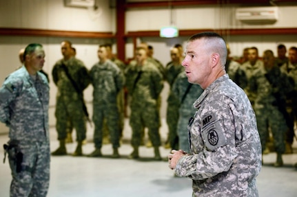 Army Lt. Col. Warren Wintrode, commander of the North Carolina National Guard's 105th Military Police Battalion, addresses the troops and explains the importance of the unit's mission during their Combat Patch Ceremony on June 1, 2010. "Don't ever stop, don’t ever let your vigilance falter. Get your game face on and be prepared to do what I know you are capable of," Wintrode said.