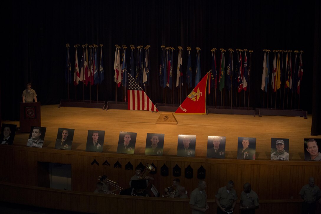 The photographs of 11 fallen service members line a theater stage, commemorating the individuals during their celebration of life ceremony, May 15, 2015, aboard Marine Corps Base Camp Lejeune, N.C. The seven MARSOC Marines and four Louisiana Army National Guardsmen pictured were killed when a UH-60 Black Hawk Helicopter crashed during amphibious operations involving helicopter and boat insertion and extraction training near Eglin, Fla., March 10. (U.S. Marine Corps photo by Cpl. Steven Fox/Released)