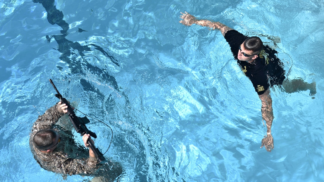 A reconnaissance Marine treads water with a rifle during a pool qualification to compete in the Recon Challenge at Marine Corps Base Camp Pendleton, California, May 14, 2015. The Recon Challenge is an annual competition of grueling tests, hosted by the Reconnaissance Training Company, Advanced Infantry Training Battalion, School of Infantry West, and conducted by volunteers from the recon community in honor of reconnaissance Marines and sailors killed in action. The challenge consisted of a 1000-meter swim with fins in the Pacific Ocean followed by an observation and memorization game, a navigation and map work test, radio and communication test, obstacle course event, weapon assembly and disassembly test, two pool challenges, fireman’s carry event, live-fire range and a knot-tying test scattered along the route to the finish line.