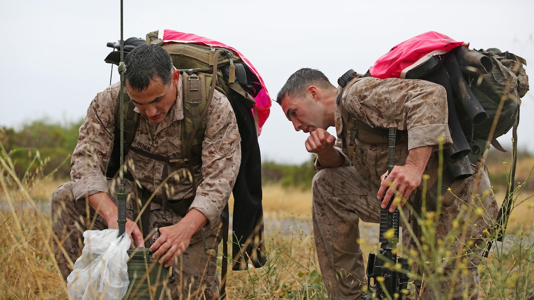 Capt. William Wellborn and Sgt. James R. Coe, reconnaissance Marines with 2nd Recon Battalion, perform a function check on a radio during the Recon Challenge at Marine Corps Base Camp Pendleton, California, May 15, 2015. The Recon Challenge is an annual competition of grueling tests, hosted by the Reconnaissance Training Company, Advanced Infantry Training Battalion, School of Infantry West, and conducted by volunteers from the recon community in honor of reconnaissance Marines and sailors killed in action. The challenge consisted of a 1000-meter swim with fins in the Pacific Ocean followed by an observation and memorization game, a navigation and map work test, radio and communication test, obstacle course event, weapon assembly and disassembly test, two pool challenges, fireman’s carry event, live-fire range and a knot-tying test scattered along the route to the finish line.