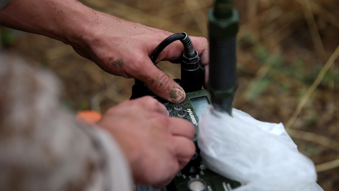 A reconnaissance Marine performs a function check on a radio during the Recon Challenge at Marine Corps Base Camp Pendleton, California, May 15, 2015. The Recon Challenge is an annual competition of grueling tests, hosted by the Reconnaissance Training Company, Advanced Infantry Training Battalion, School of Infantry West, and conducted by volunteers from the recon community in honor of reconnaissance Marines and sailors killed in action. The challenge consisted of a 1000-meter swim with fins in the Pacific Ocean followed by an observation and memorization game, a navigation and map work test, radio and communication test, obstacle course event, weapon assembly and disassembly test, two pool challenges, fireman’s carry event, live-fire range and a knot-tying test scattered along the route to the finish line.