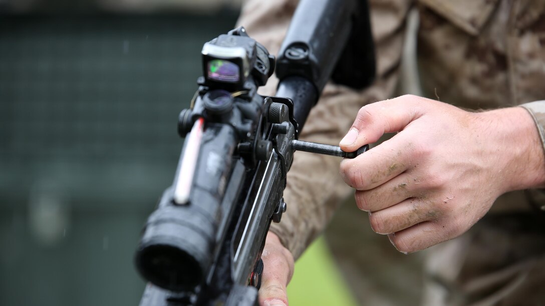 A reconnaissance Marine disassembles an M4 assault rifle during the Recon Challenge at Marine Corps Base Camp Pendleton, California, May 15, 2015. The Recon Challenge is an annual competition of grueling tests, hosted by the Reconnaissance Training Company, Advanced Infantry Training Battalion, School of Infantry West, and conducted by volunteers from the recon community in honor of reconnaissance Marines and sailors killed in action. The challenge consisted of a 1000-meter swim with fins in the Pacific Ocean followed by an observation and memorization game, a navigation and map work test, radio and communication test, obstacle course event, weapon assembly and disassembly test, two pool challenges, fireman’s carry event, live-fire range and a knot-tying test scattered along the route to the finish line.