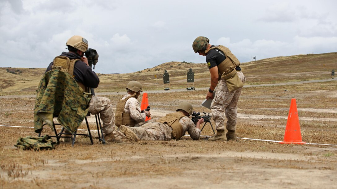 A reconnaissance Marine fires an M249 squad automatic weapon during the Recon Challenge at Marine Corps Base Camp Pendleton, California, May 15, 2015. The Recon Challenge is an annual competition of grueling tests, hosted by the Reconnaissance Training Company, Advanced Infantry Training Battalion, School of Infantry West, conducted by volunteers from the recon community in honor of reconnaissance Marines and sailors killed in action. The challenge consisted of a 1000-meter swim with fins in the Pacific Ocean followed by an observation and memorization game, a navigation and map work test, radio and communication test, obstacle course event, weapon assembly and disassembly test, two pool challenges, fireman’s carry event, live-fire range and a knot-tying test scattered along the route to the finish line.
