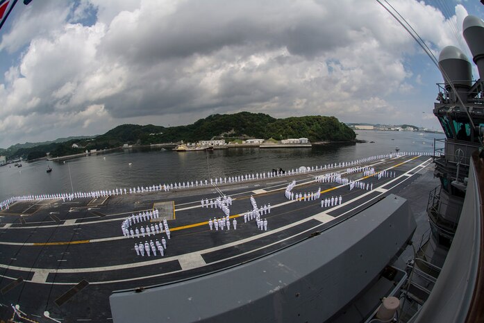 TOKYO BAY (May 18, 2015) - Sailors aboard the aircraft carrier USS George Washington (CVN 73) stand in formation selling "goodbye" in Japanese as the ship departs for its 2015 patrol. Following operations in U.S. 7th Fleet, George Washington will conduct a hull swap with the aircraft carrier USS Ronald Reagan (CVN 76) this summer, after having served as the U.S. Navy's forward deployed aircraft carrier for seven years. George Washington and its embarked air wing, Carrier Air Wing (CVW) 5, provide a combat-ready force that protects and defends the collective maritime interests of the U.S. and its allies and partners in the Indo-Asia-Pacific region. 
