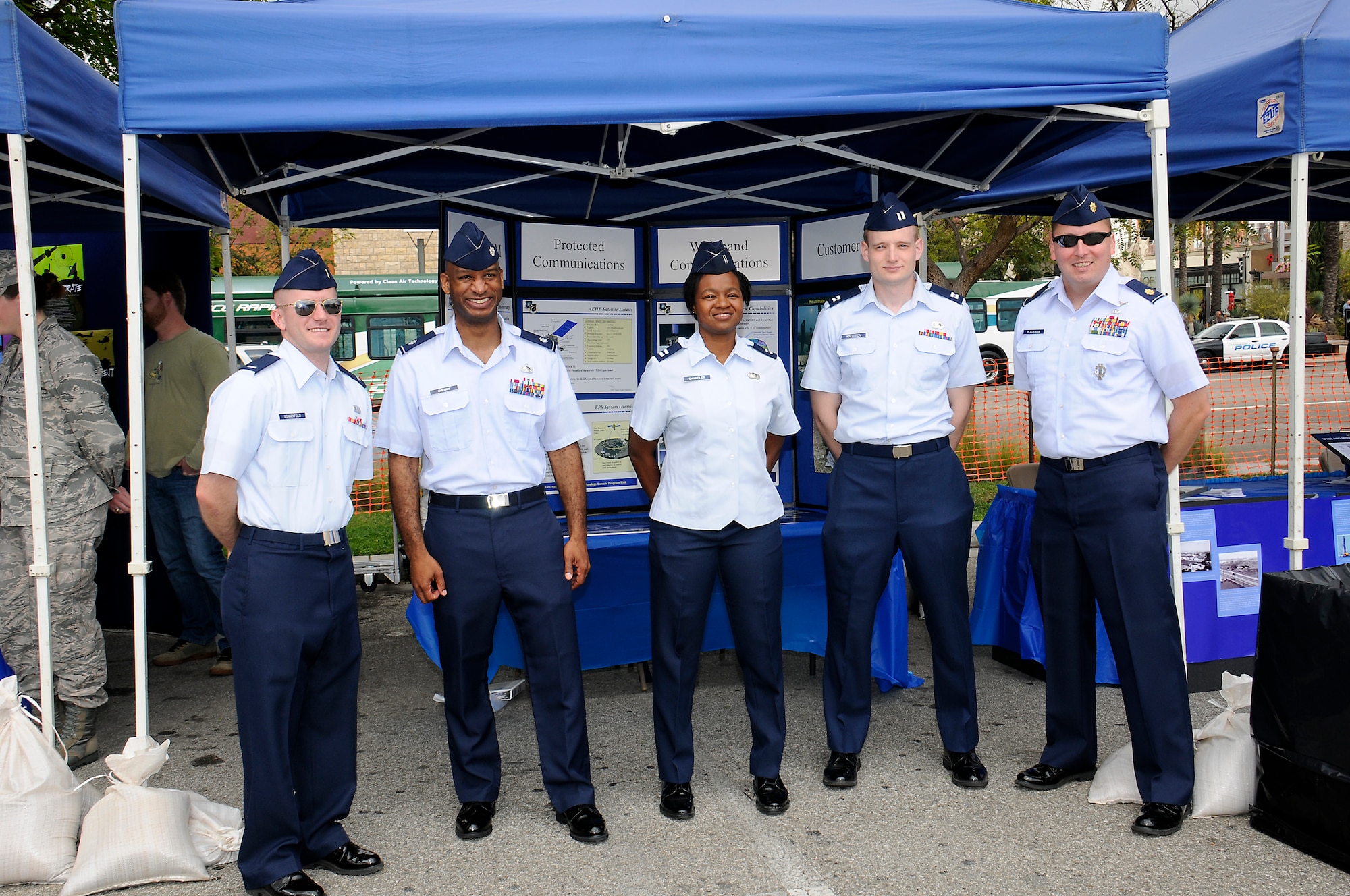 Airmen from SMC’s MILSATCOM Directorate stand  in front of the directorate’s display at the Del Amo Mall, May 16