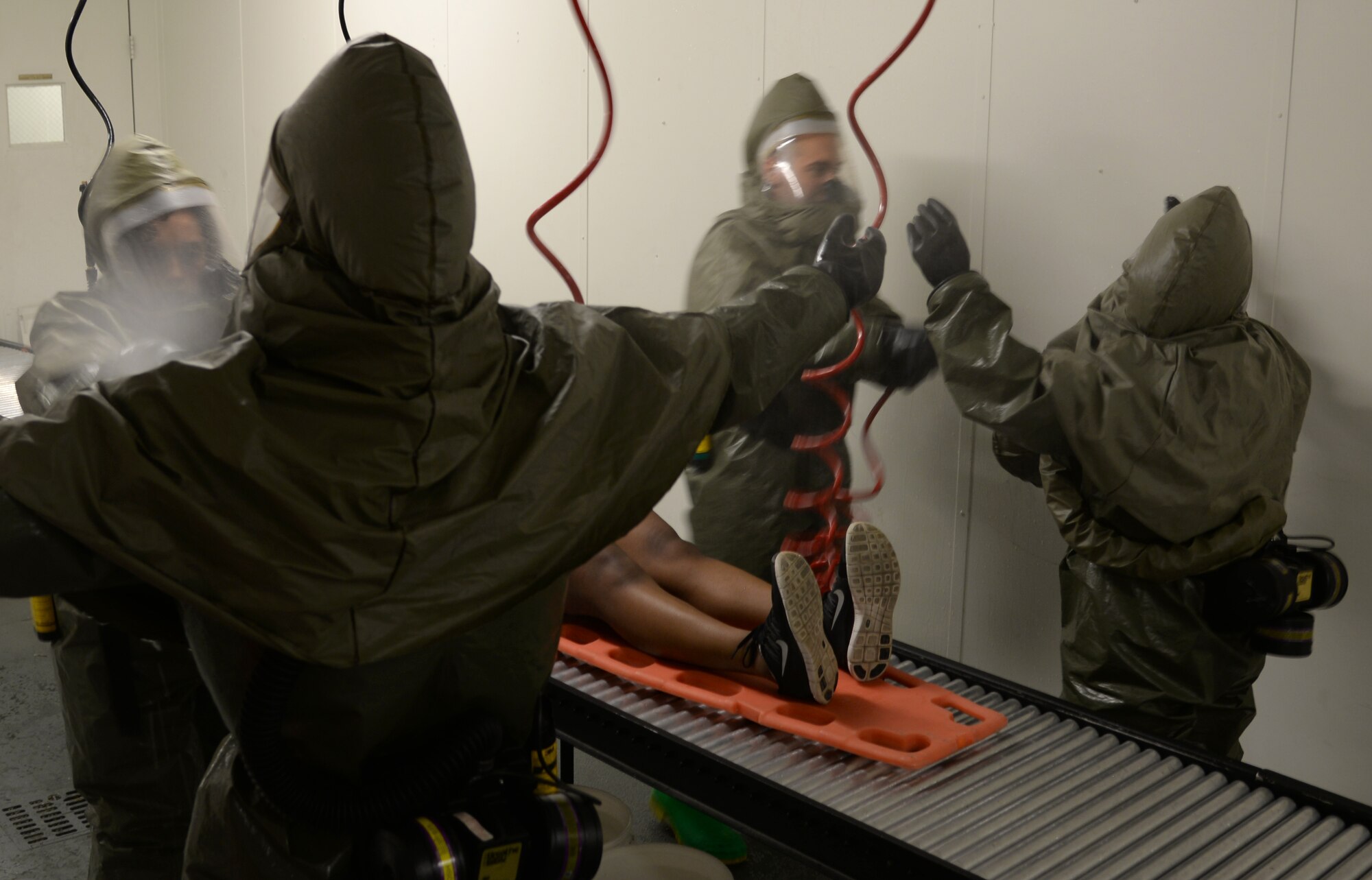 Members of the 51st Medical Group practice wash simulated contamination off of each other during a readiness exercise May 14, 2015, at Osan Air Base, Team Osan is participating in the combat exercise Beverly Midnight 15-02 which is designed to test American forces in the ROK on their mission readiness in the event of an emergency or wartime environment. (U.S. Air Force photo by Staff Sgt. Benjamin Sutton/Released) 