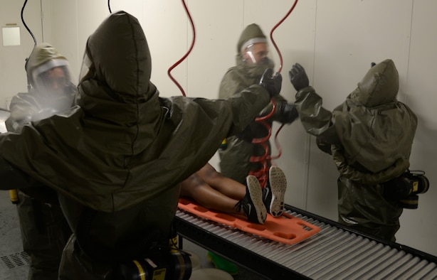 Members of the 51st Medical Group practice wash simulated contamination off of each other during a readiness exercise May 14, 2015, at Osan Air Base, Team Osan is participating in the combat exercise Beverly Midnight 15-02 which is designed to test American forces in the ROK on their mission readiness in the event of an emergency or wartime environment. (U.S. Air Force photo by Staff Sgt. Benjamin Sutton/Released) 