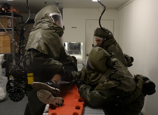 Members of the 51st Medical Group practice washig a simulated victim of contamination during a readiness exercise May 14, 2015, at Osan Air Base, The Airmen worked throughout the night to get simulated victims the necessary medical care during the readiness exercise Beverly Midnight 15-02. (U.S. Air Force photo by Staff Sgt. Benjamin Sutton/Released) 