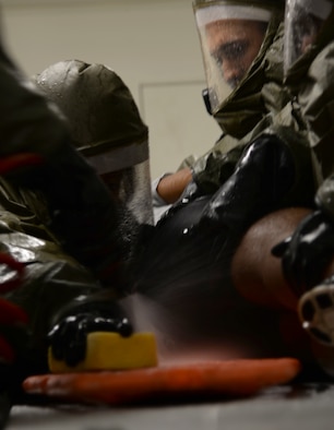 Members of the 51st Medical Group wash a simulated victim of contamination during a readiness exercise May 14, 2015, at Osan Air Base, Republic of Korea. The scenario was part of the readiness exercise Beverly Midnight 15-02 was designed to test the capabilities of Team Osan. (U.S. Air Force photo by Staff Sgt. Benjamin Sutton/Released) 