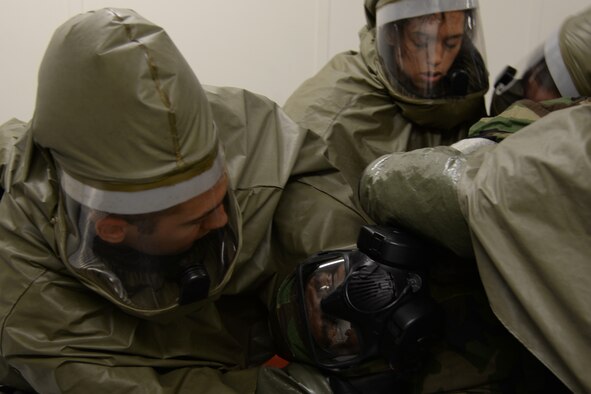 Members of the 51st Medical Group practice chemical cleaning procedures on a simulated victim May 14, 2015, at Osan Air Base, Republic of Korea. The Airmen are participating in the combat readiness exercise Beverly Midnight 15-02. The exercise focuses on readiness, testing Osan’s wartime procedures, and realistically looking at our ability to defend the base, execute operations and receive follow-on forces. (U.S. Air Force photo by Staff Sgt. Benjamin Sutton/Released) 