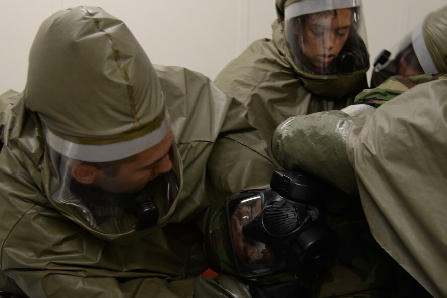 Members of the 51st Medical Group practice chemical cleaning procedures on a simulated victim May 14, 2015, at Osan Air Base, Republic of Korea. The Airmen are participating in the combat readiness exercise Beverly Midnight 15-02. The exercise focuses on readiness, testing Osan’s wartime procedures, and realistically looking at our ability to defend the base, execute operations and receive follow-on forces. (U.S. Air Force photo by Staff Sgt. Benjamin Sutton/Released) 
