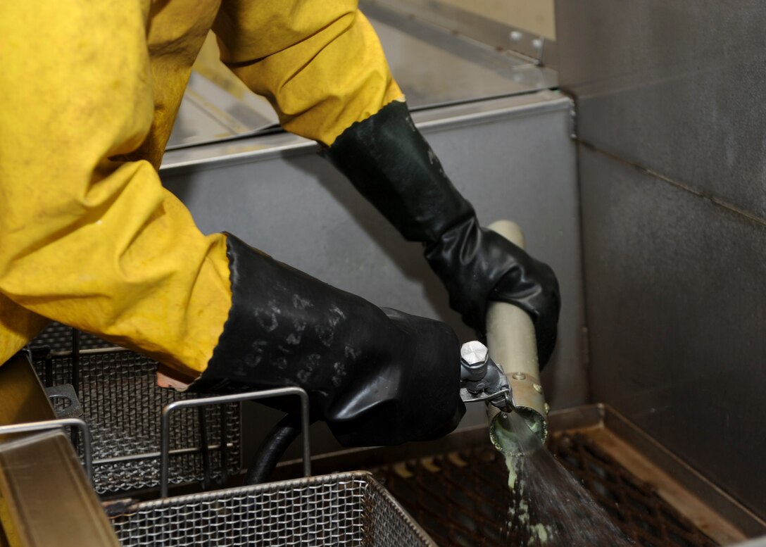 Airman 1st Class Royston Bedminster, 28th Maintenance Squadron nondestructive inspection technician, rinses excess penetrant liquid from an actuator during a nondestructive inspection process at Ellsworth Air Force Base, S.D., May 8, 2015. If an inspection reveals imperfections of aircraft parts, the part is sent to shops on base where they can be repaired or replaced. (U.S. Air Force photo by Senior Airman Anania Tekurio/Released)