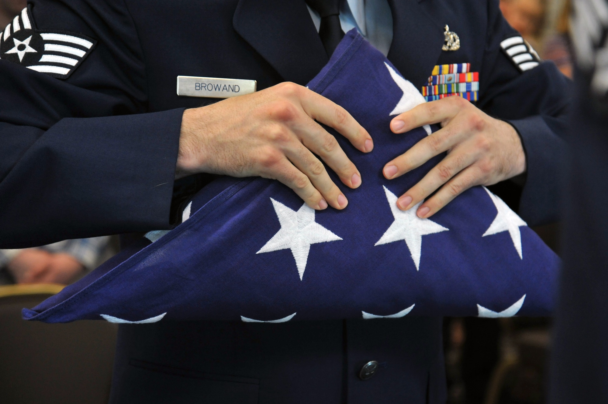 Staff Sgt. Spencer Browand, 92nd Maintenance Squadron aircraft fuel systems craftsman, ensures there is no red showing after completing a six-man flag fold during his Honor Guard graduation May 15, 2015, in the Red Morgan Center at Fairchild Air Force Base, Wash. Airmen practice techniques for 12 days before performing in a service. Fairchild’s honor guard performs military honors for various events and ceremonies in parts of Washington, Idaho and Oregon. (U.S. Air Force photo/Staff Sgt. Samantha Krolikowski) 