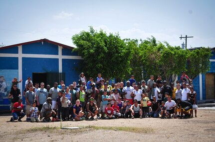Volunteers from Joint Task Force-Bravo pose for a group photo with boys from the Saint Anthony of Padua Boys Home outside La Paz, Honduras May 16, 2015. The 1st Battalion, 228th Aviation Regiment from Soto Cano Air Base leads monthly visits to local orphanages around Soto Cano Air Base, to serve the community. (U.S. Air Force photo by Capt. Christopher Love)