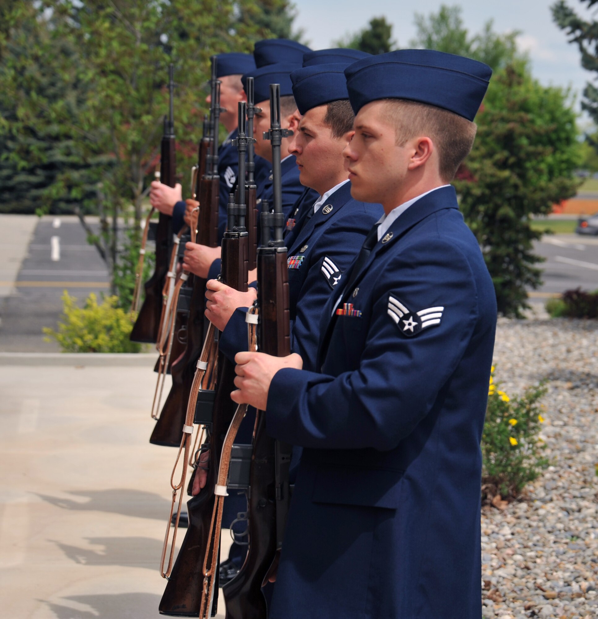 Fairchild Honor Guard graduates perform firing party drills during their graduation ceremony May 15, 2015, in the Red Morgan Center at Fairchild Air Force Base, Wash. Honor guard trainees fire a three-volley rifle salute in a simulated 21-gun formation during their graduation. The three shots signify duty, honor and country. (U.S. Air Force photo/Staff Sgt. Samantha Krolikowski)