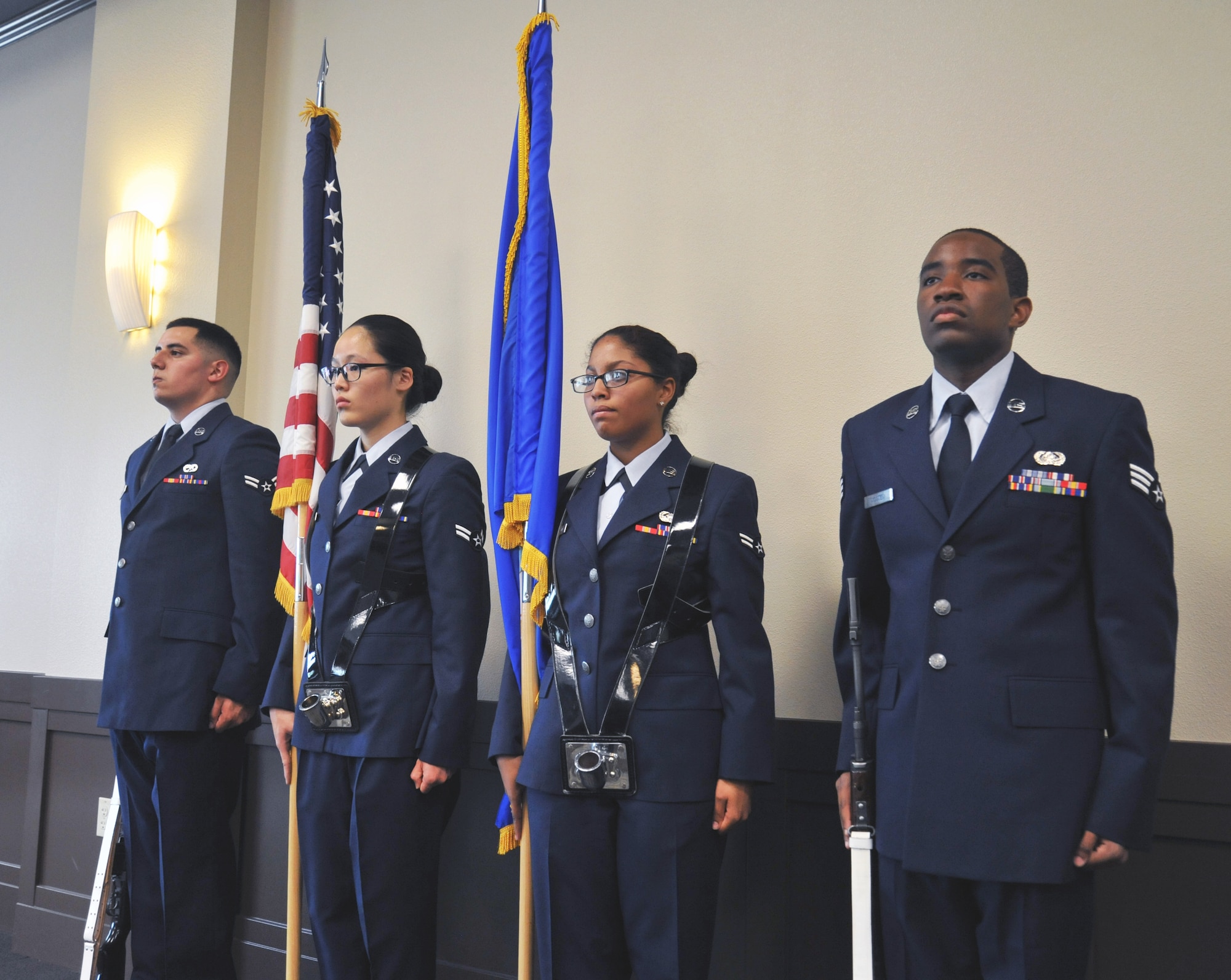 Fairchild Honor Guard graduates performing color guard duties wait for their cue to begin during their Honor Guard graduation May 15, 2015, in the Red Morgan Center at Fairchild Air Force Base, Wash. Airmen practice techniques for 12 days before performing in a service. Fairchild’s honor guard performs military honors for various events and ceremonies in parts of Washington, Idaho and Oregon. (U.S. Air Force photo/Staff Sgt. Samantha Krolikowski) 