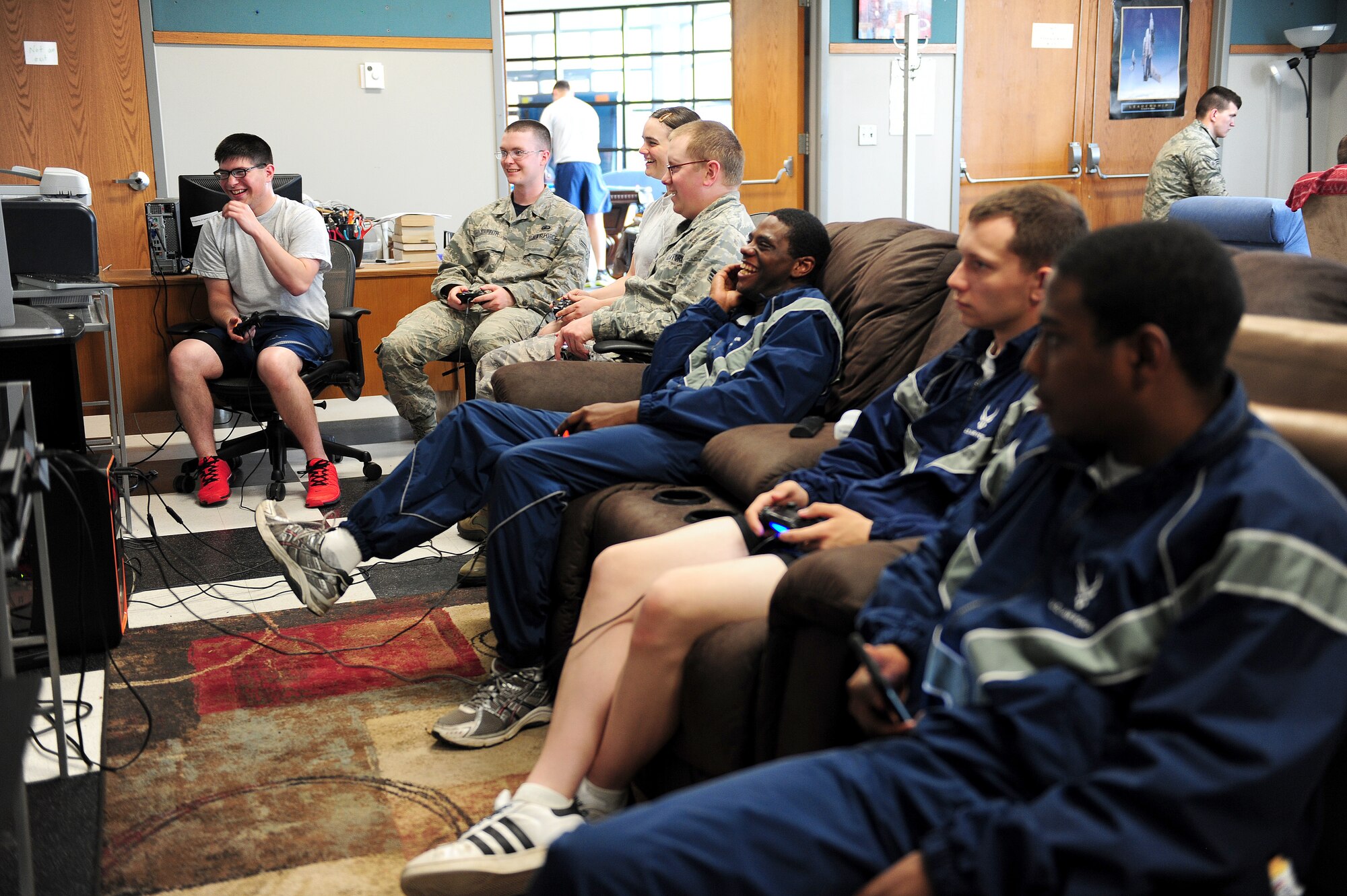 Airmen gather at the Spirit Café to play video games May 15, 2015, at Whiteman Air Force Base, Mo. The “Gamer’s Guild” offered had an array of game consoles, Magic card games, computer games and more. (U.S. Air Force photo by Airman Jazmin Smith/Released)
