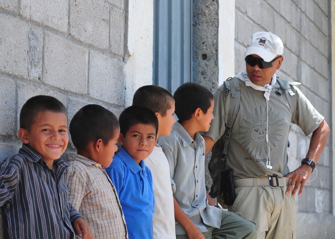 U.S. Army Sgt. Tia Sokimson, American Forces Network Honduras combat videographer, speaks with a row of boys from the Saint Anthony of Padua Boys Home outside La Paz, Honduras May 16, 2015. Sokimson volunteered to spend his morning with the boys as part of a monthly orphanage visit sponsored by the 1st Battalion, 228th Aviation Regiment from Soto Cano Air Base. (U.S. Air Force photo by Capt. Christopher Love)