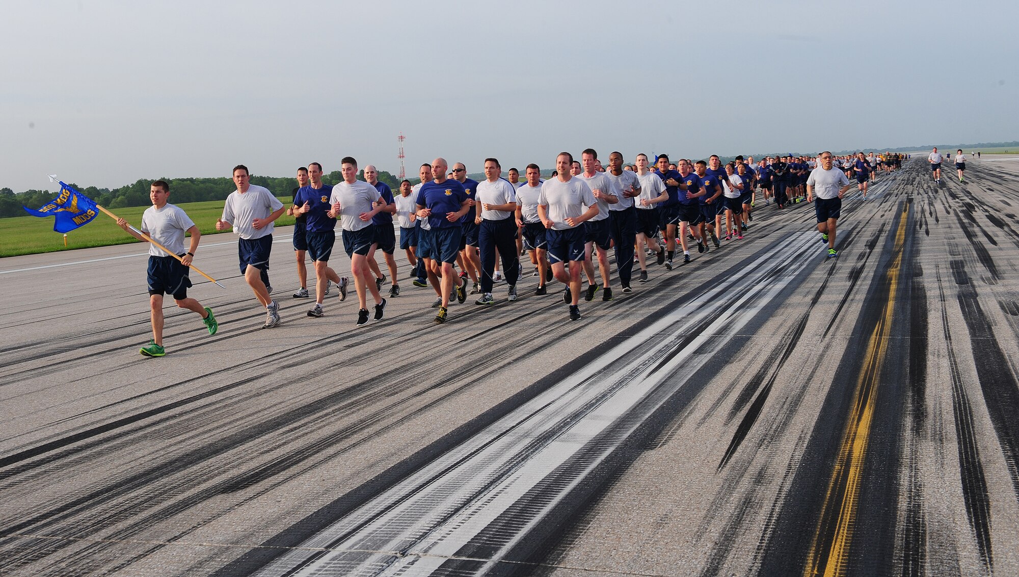 Squadrons participate in the 1.5-mile run on the flightline May 15, 2015, at Whiteman Air Force Base, Mo. After hearing from Brig. Gen. Glen VanHerck, 509th Bomb Wing commander, each flight bearing their unit’s guidon took off with their team singing jodies. (U.S. Air Force photo by Airman Jazmin Smith/Released)