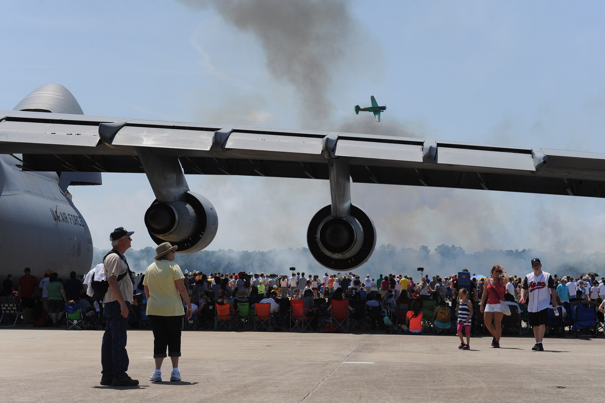 Spectators watch the “Tora! Tora! Tora!” demonstration during the 2015 Wings Over Wayne Airshow and Open House, May 17, 2015, at Seymour Johnson Air Force Base, North Carolina. The performance is a reenactment of the Japanese attacks on Pearl Harbor that led to the U.S. entering World War II. (U.S. Air Force photo/Airman 1st Class Aaron J. Jenne)