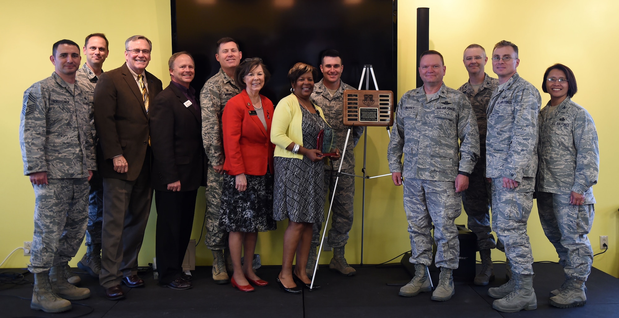 Base and community leaders stand with Lisa R. Buckley, American Automation Building Solutions Inc. chief of operations, seventh from left; after the Community Heroes of Buckley event May 14, 2015, at the Panther Den on Buckley Air Force Base, Colo. Every year, Buckley Air Force Base recognizes one individual from the local community for their efforts made toward supporting Team Buckley by presenting them the Community Hero of Buckley award. (U.S. Air Force Photo by Airman 1st Class Emily E. Amyotte/Released)