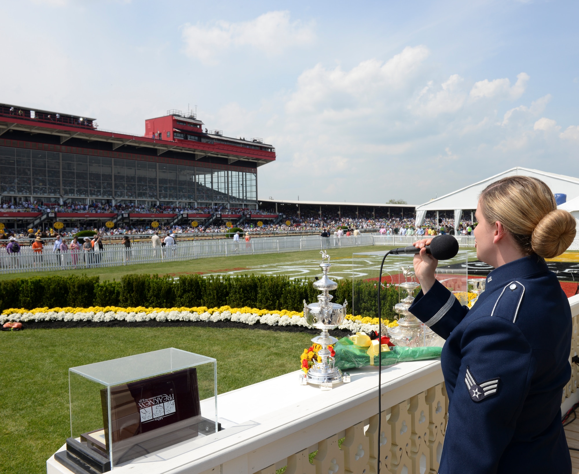 Senior Airman Melissa Lackore performs "America the Beautiful" for a record crowd at the Preakness Stakes May 16, 2015 in Baltimore, Maryland. Lackore is a member of the newest ensemble of the Heritage of America Band, Full Spectrum. The event, which was nationally televised, broke records in attendance by hosting more than 170,000 people.