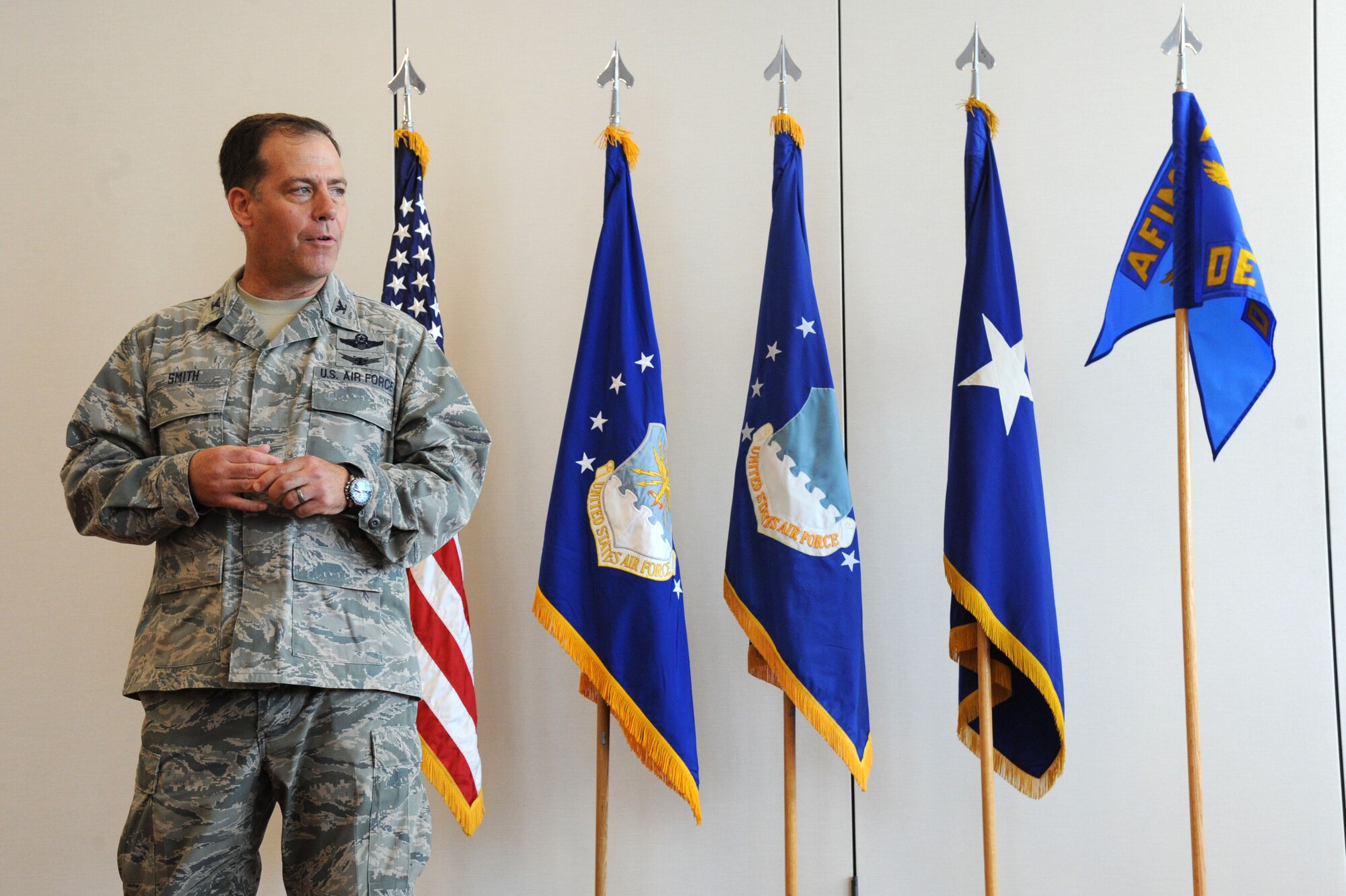 Col. Michael Smith addresses the audience after assuming command of the Air Force Installation and Mission Support Center’s Detachment 5 at Joint Base Andrews, Maryland, May 18, 2015. Airmen assigned to AFIMSC will assume responsibility for a number of mission support functions to include services, civil engineering, security forces, finance, and contracting, allowing major commands and direct reporting units to focus on primary mission areas. (U.S. Air Force photo/Master Sgt. Tammie Moore)
