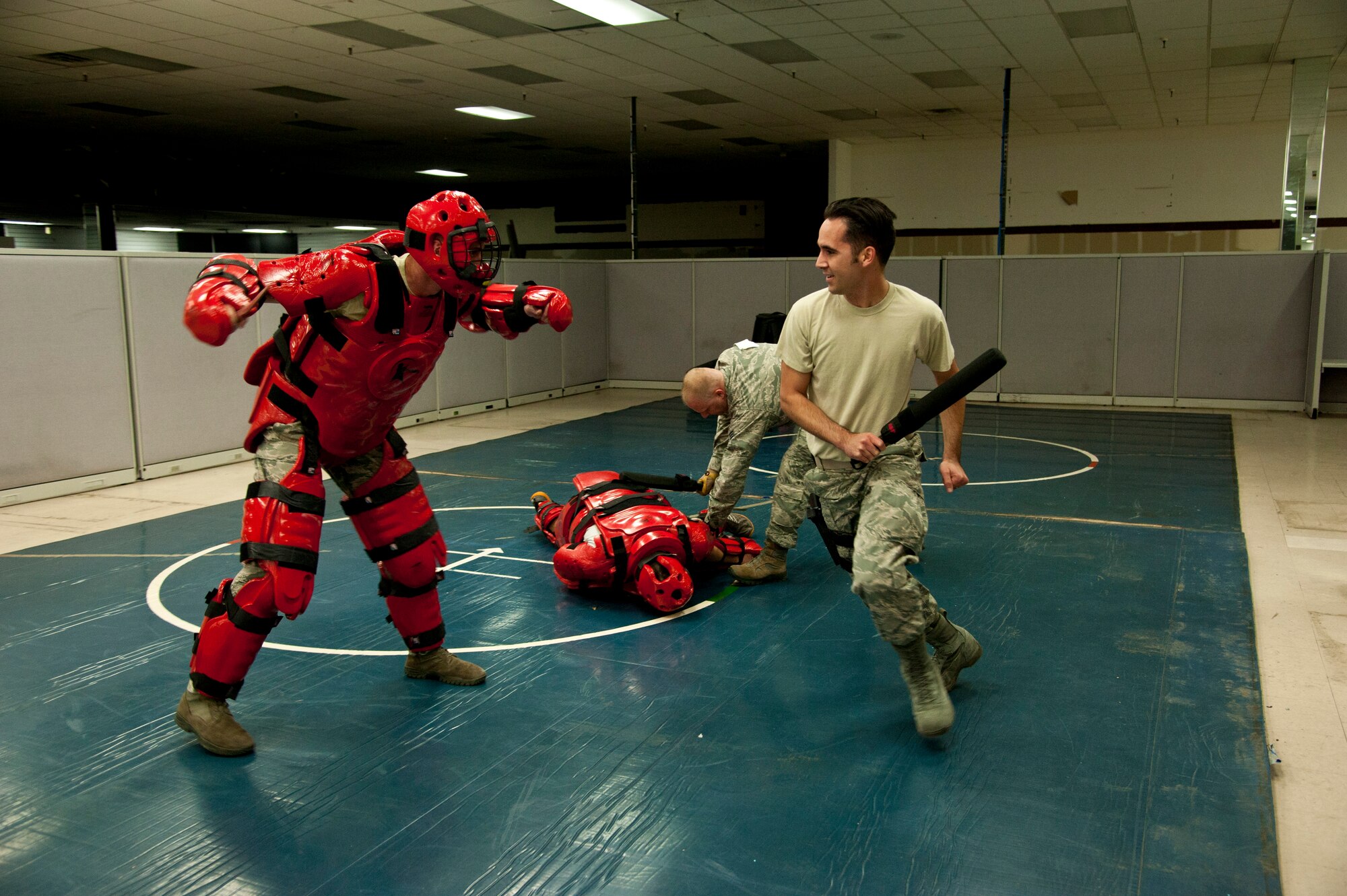 PETERSON AIR FORCE BASE, Colo. – Staff Sgt. Eric Leyva, 50th Space Control Squadron, and Tech. Sgt. Timothy Tichawa, Advanced Space Operations School, participate in close quarters combat as part of the shoot house challenge in recognition of Police Week at the 21st SFS Training Center, May 14, 2015. The shoot house challenge consisted of several obstacles including tire flipping, physical training, door breaching, target shooting with weapons equipped with lasers, close quarters combat and a dummy drag. (U.S. Air Force photo by Senior Airman Tiffany DeNault)
