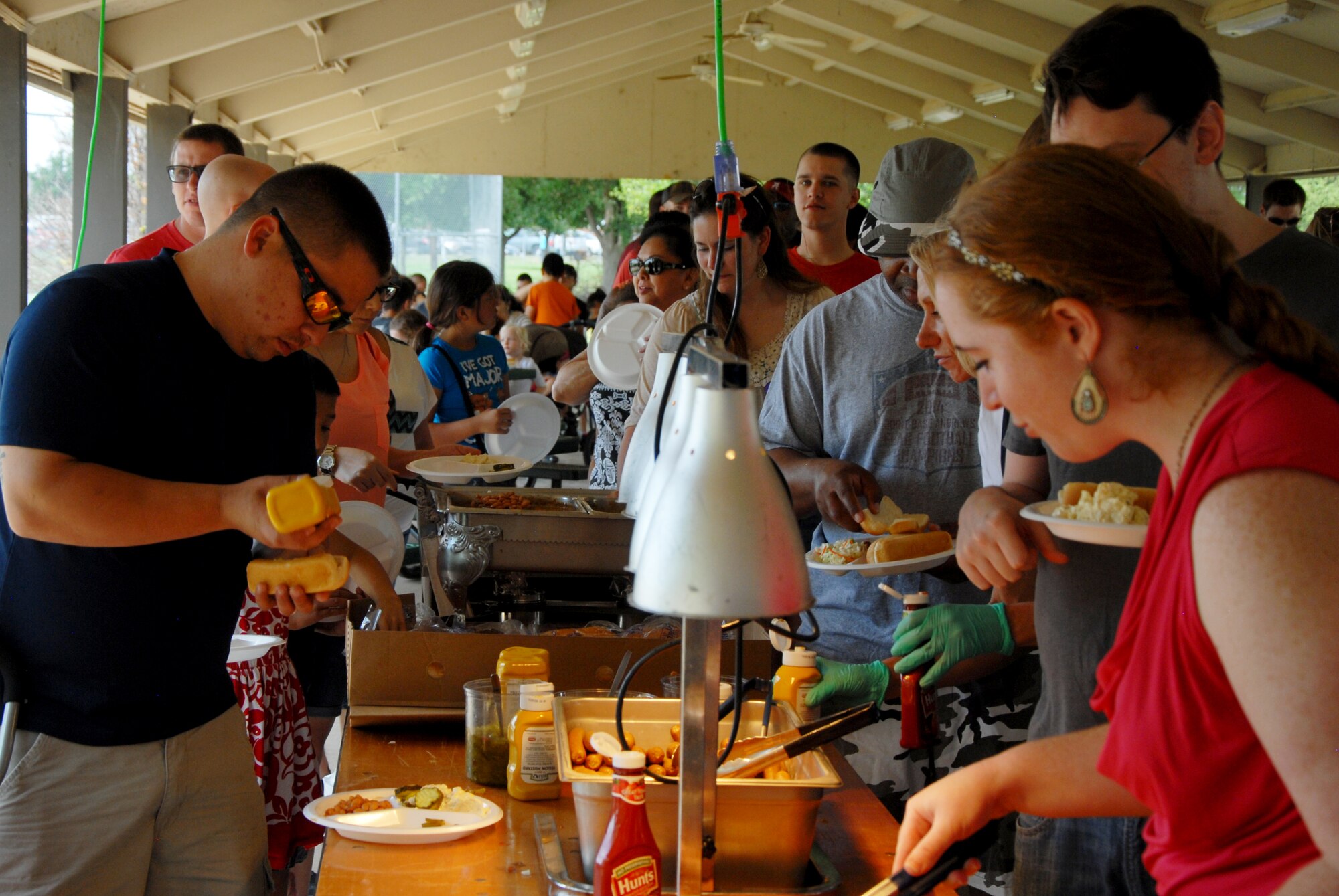 Goodfellow members pick their meals during Goodfellow Appreciation Day at the Goodfellow Recreation Camp in San Angelo, Texas, May 16, 2015. The San Angelo Chamber of Commerce and its sponsors provided a free event to service members, base civilians and their families for Armed Forces Day. (U.S. Air Force photo by Senior Airman Joshua Edwards/ Released)