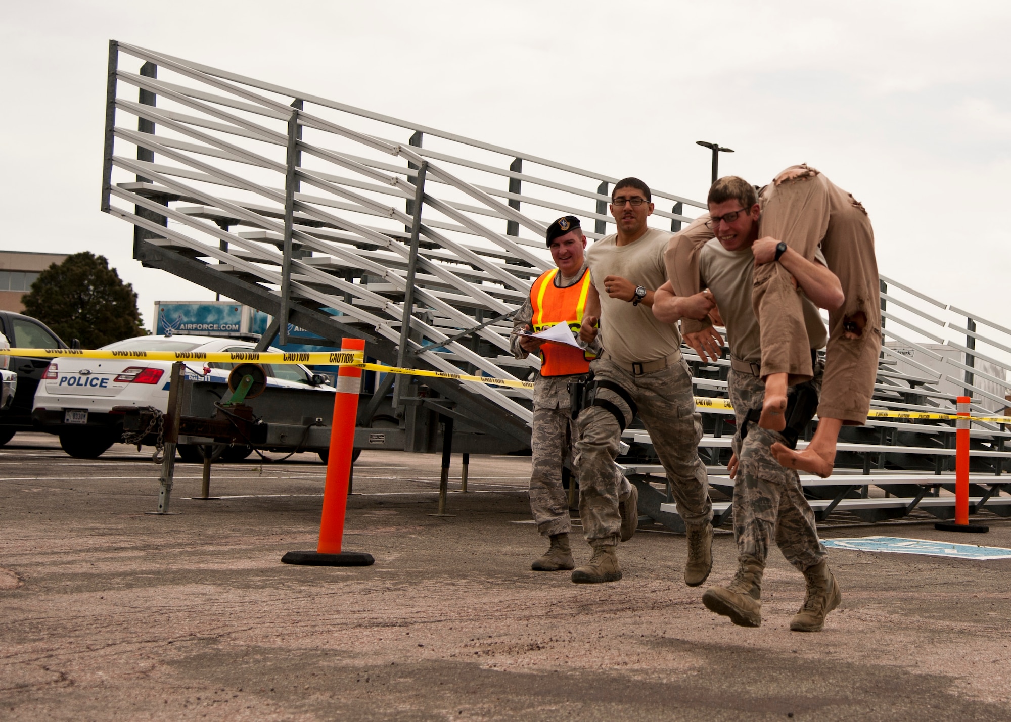 PETERSON AIR FORCE BASE, Colo. – Senior Airman James Santiago and Airman 1st Class Joseph Dimperio, 13th Air Support Operations Squadron, race to the finish at the last shoot house challenge station in recognition of Police Week at the 21st SFS Training Center, May 15, 2015. The shoot house challenge consisted of several obstacles including tire flipping, physical training, door breaching, target shooting with weapons equipped with lasers, close quarters combat and a dummy drag. (U.S. Air Force photo by Senior Airman Tiffany DeNault)