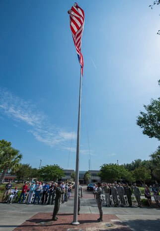Defenders from the 628th Security Forces Squadron lower the flag May 15, 2015 at Joint Base Charleston, S.C., during a police week retreat ceremony.  The week is celebrated nationally to remember those who have been killed in the line of duty. (U.S. Air Force photo/Senior Airman Jared Trimarchi)