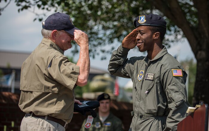 Retired Col. Lawrence Lane, the first Phoenix Raven, salutes Staff Sgt. Chris Moore, the newest 628th Security Forces Squadron Raven, May 15, 2015 at Joint Base Charleston, S.C., during a police week retreat ceremony. Ravens are security forces members who are extensively trained to provide security for Air Mobility Command aircraft transiting through high threat areas. The week is celebrated nationally to remember those who have been killed in the line of duty. (U.S. Air Force photo/Senior Airman Jared Trimarchi)