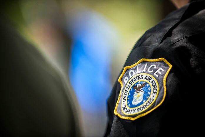 A police officer and member of the 628th Security Forces Squadron stands in formation May 15, 2015 at Joint Base Charleston, S.C., during a police week retreat ceremony. The week is celebrated nationally to remember those who have been killed in the line of duty. (U.S. Air Force photo/Senior Airman Jared Trimarchi)