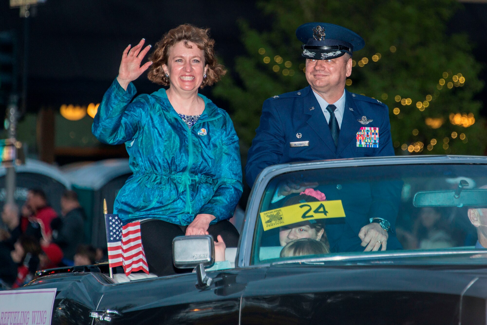 Col. Brian McDaniel, 92nd Air Refueling Wing commander, and his wife, Deborah, wave at crowds from their classic car during the 77th Annual Spokane Lilac Festival Armed Forces Torchlight Parade May 16, 2015, in downtown Spokane, Wash. This parade affords community members an opportunity to remember the sacrifice and service of the nation’s military men and women and respect the rich heritage of the Inland Northwest, past and present. (U.S. Air Force photo/Staff Sgt. Benjamin W. Stratton)